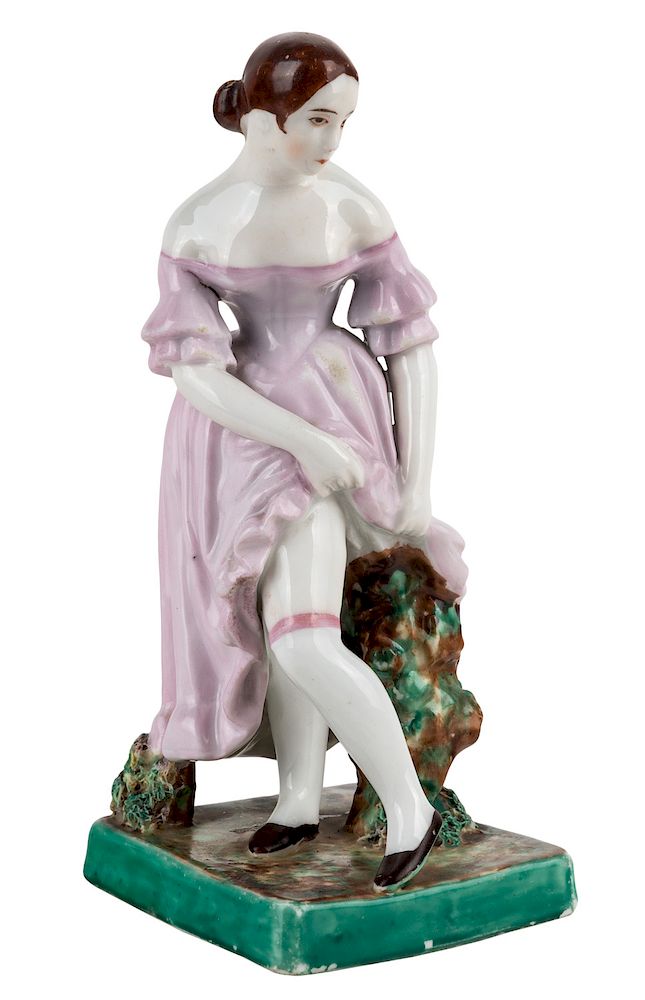 Appraisal: A RUSSIAN PORCELAIN FIGURE OF A YOUNG WOMAN IN STOCKINGS