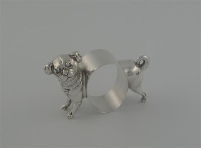 Appraisal: A modern napkin ring in the form of a dog