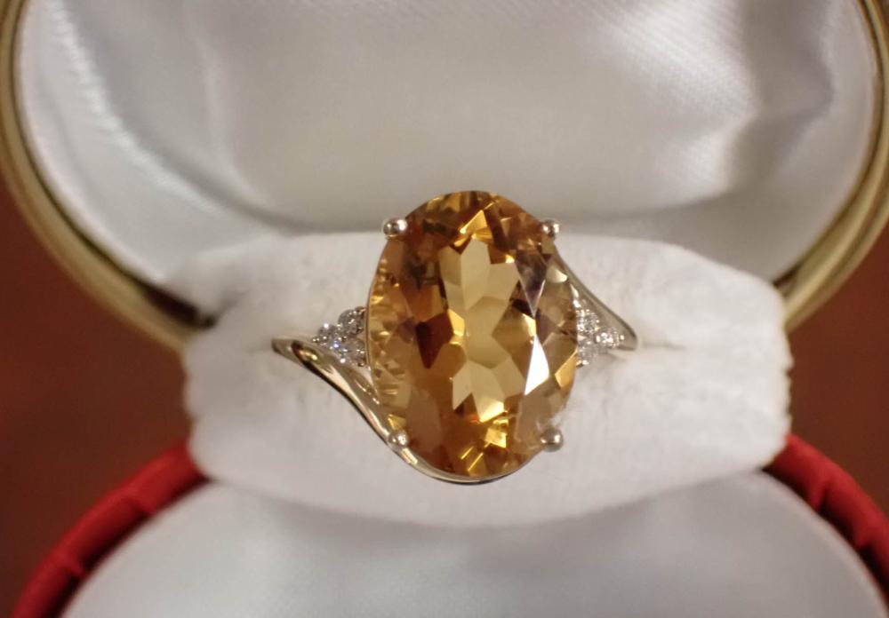 Appraisal: CITRINE DIAMOND AND FOURTEEN KARAT YELLOW GOLD RING with three