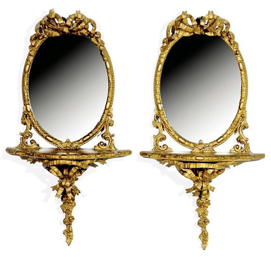 Appraisal: Pair Continental giltwood and mirrored sconces late th century oval