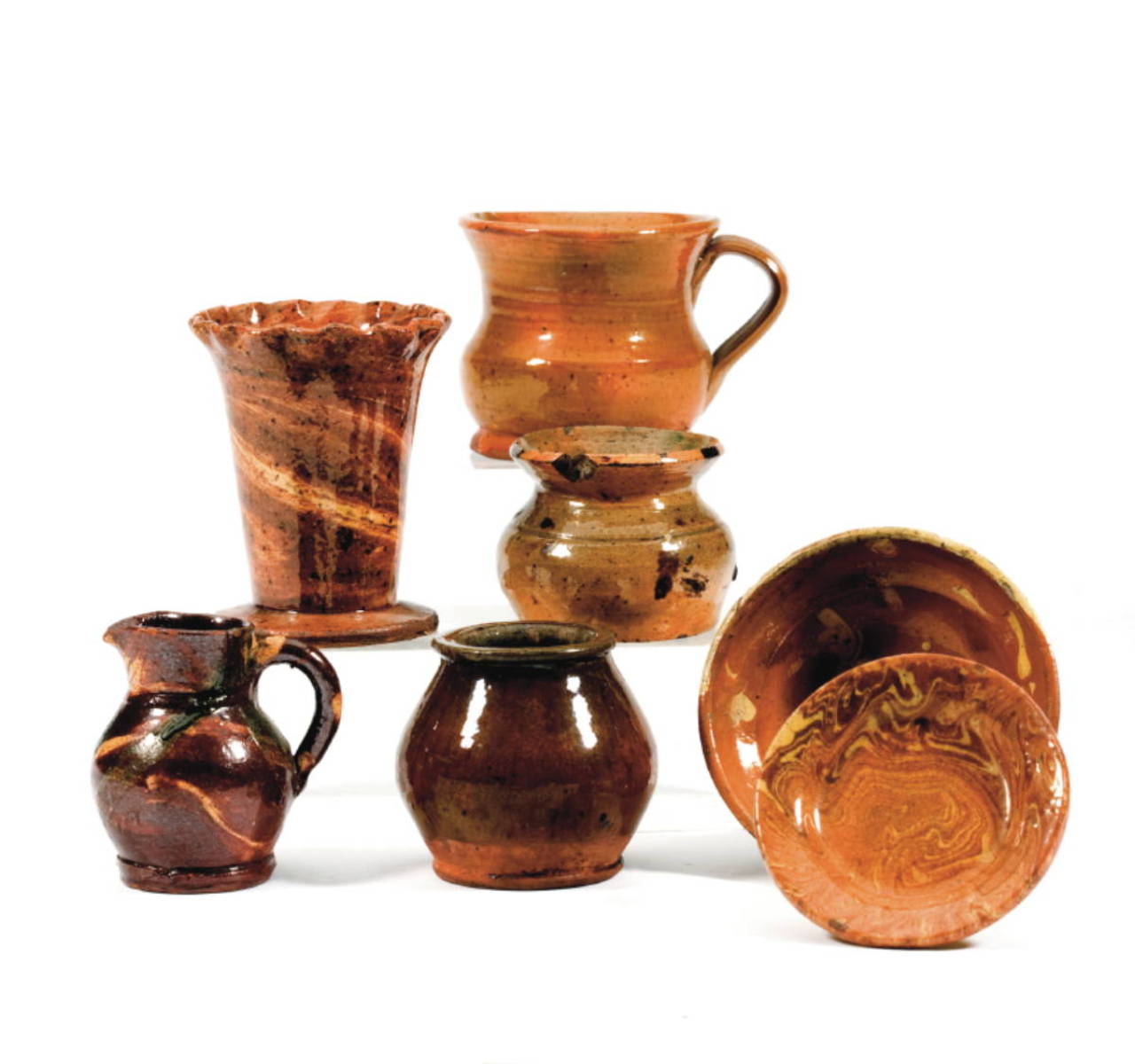 Appraisal: SEVEN GLAZED AND SLIP-DECORATED REDWARE STONEWARE AND SOLID AGATE WARES