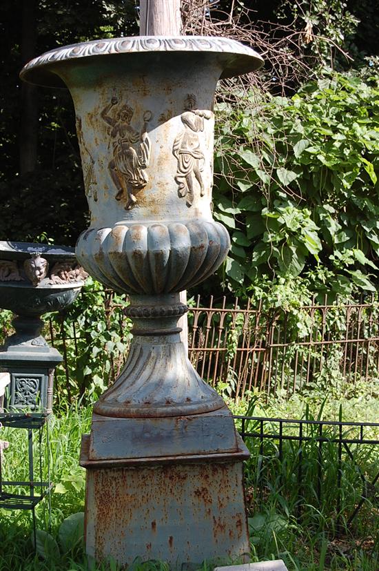 Appraisal: A MONMUNTAL PAIR CAST IRON URNS Figural design Urn H