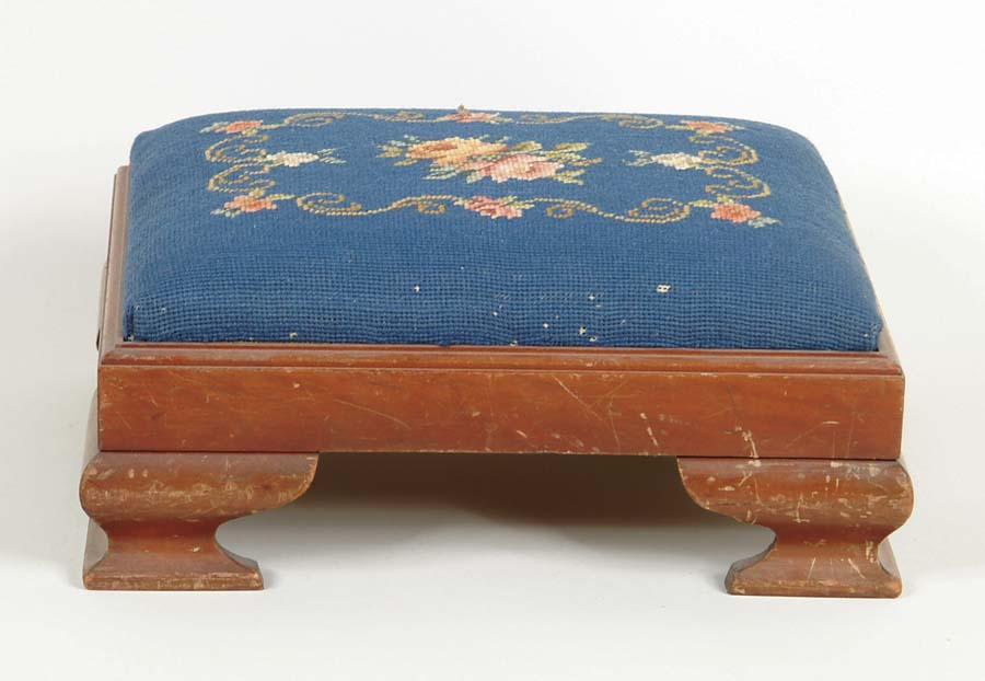 Appraisal: NEEDLEWORK TOP FOOTSTOOL Ogee feet blue floral decorated needlework cushion