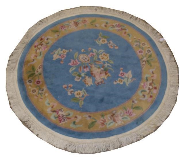 Appraisal: Chinese circular rug with floral border blue ground with central