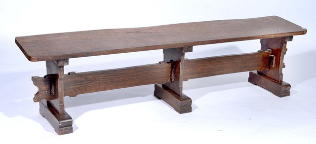 Appraisal: AN OAK FORM BENCH with shaped supports and pegged frame