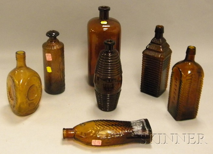 Appraisal: Seven Assorted Amber Molded Glass Bottles a Tippecanoe a fish-form