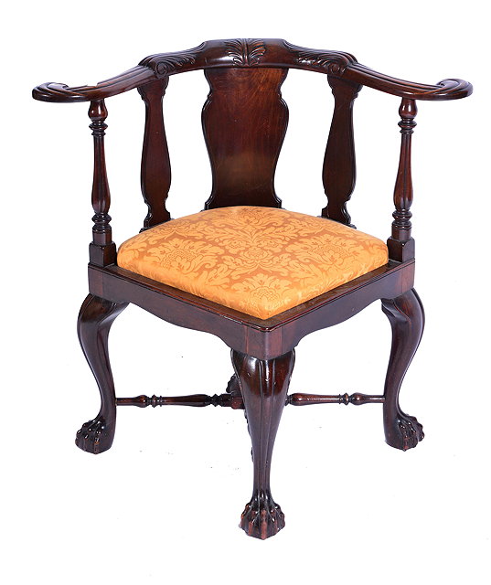 Appraisal: A TH CENTURY MAHOGANY CORNER CHAIR with carved scrolling supports