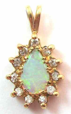 Appraisal: OPAL AND DIAMOND PENDANT k yellow gold set with eleven