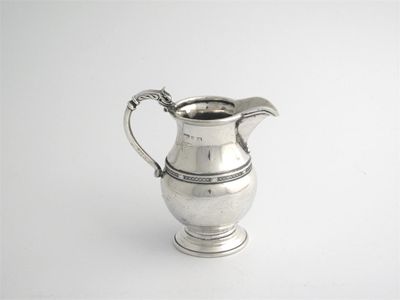 Appraisal: A th century milk jug with a griffon shell handle