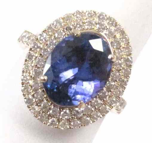 Appraisal: TANZANITE DIAMOND AND FOURTEEN KARAT GOLD RING Round-cut diamonds surround