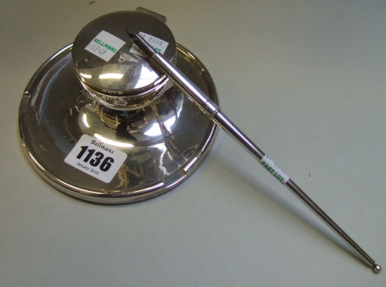 Appraisal: A silver circular capstan shaped inkstand with a hinged circular