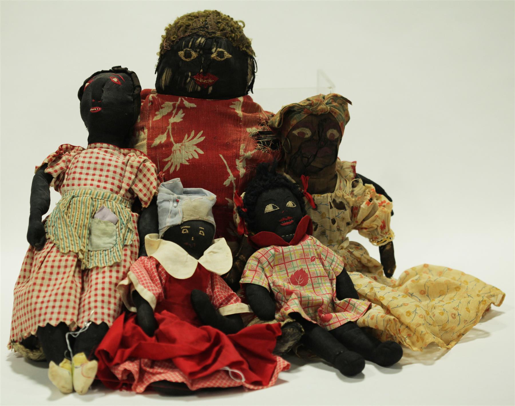 Appraisal: FIVE BLACK CLOTH DOLLS These th-century dolls have varying degrees