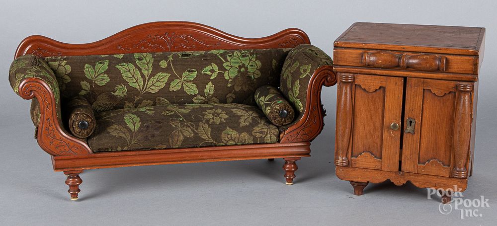 Appraisal: Carved walnut doll sofa Carved walnut doll sofa with foliate