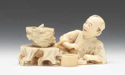 Appraisal: A Japanese Carved Ivory Miniature Okimono Beautifully carved recumbent figure