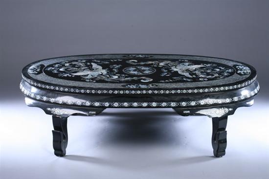 Appraisal: CHINESE MOTHER-OF-PEARL INLAID BLACK LACQUERED OVAL LOW TABLE Top has