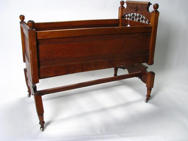 Appraisal: Victorian Walnut Baby Cradle with spring rocking mechanism stone castors