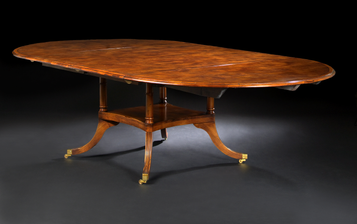 Appraisal: Regency-Style Mahogany Dining Table the banded circular bi-sected top opening