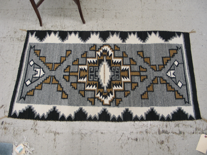 Appraisal: A NAVAJO TWO GREY HILLS DESIGN RUG The central concentric