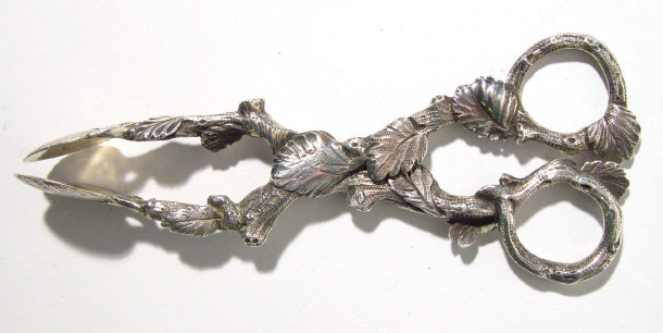 Appraisal: Pair of Victorian silver sugar nips with naturalistic leaf design