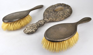 Appraisal: Two engine-turned silver-backed hairbrushes Birmingham to w an embossed hand-mirror