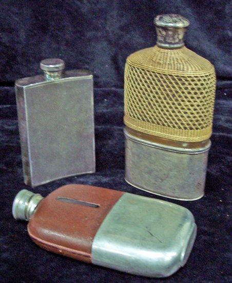 Appraisal: A Victorian glass pocket flask with cane covered bottle and