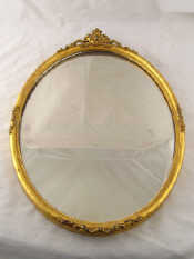 Appraisal: An oval mirror with gilt frame and shell cresting x