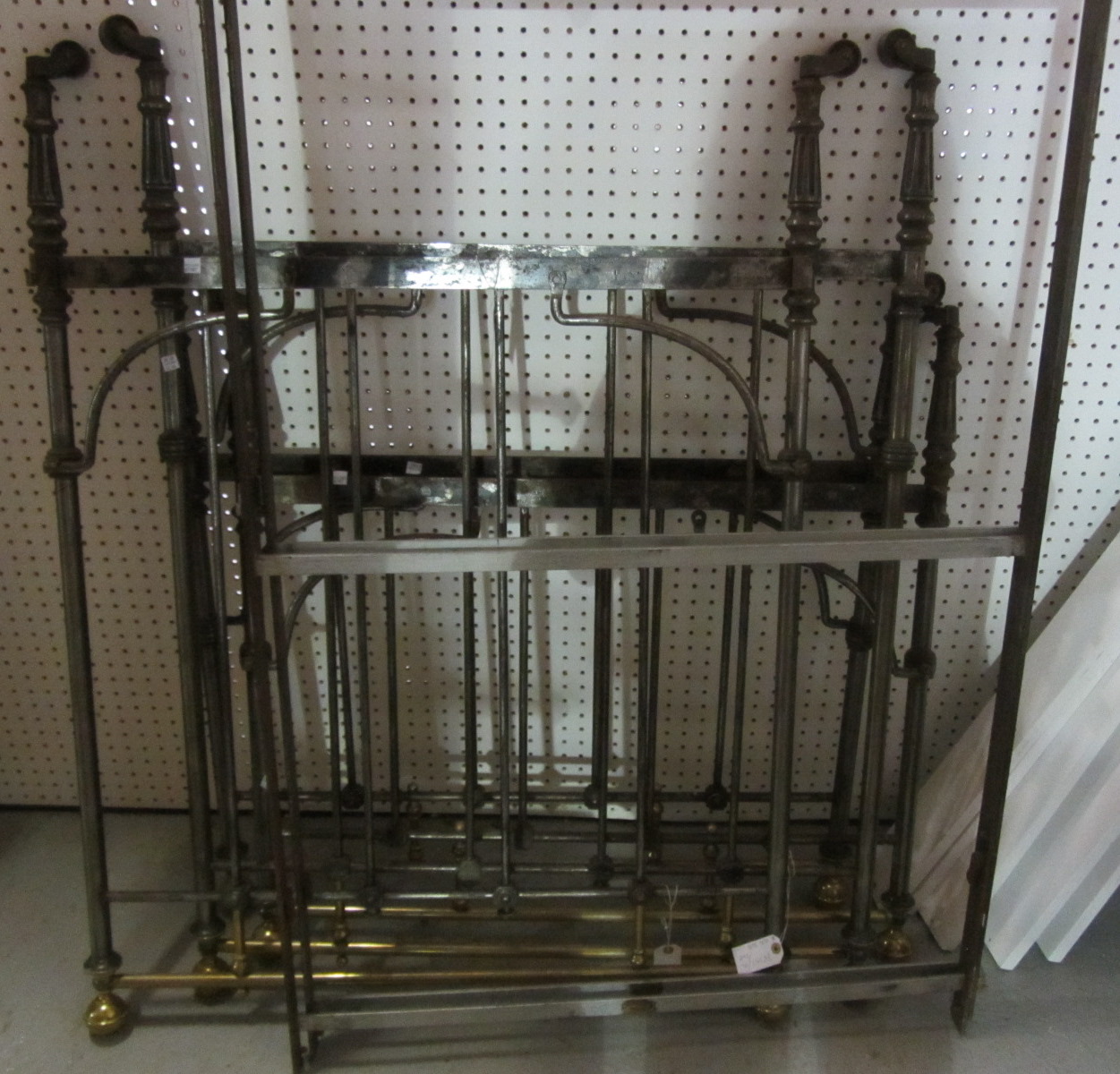 Appraisal: A pair of th century steel and brass single beds