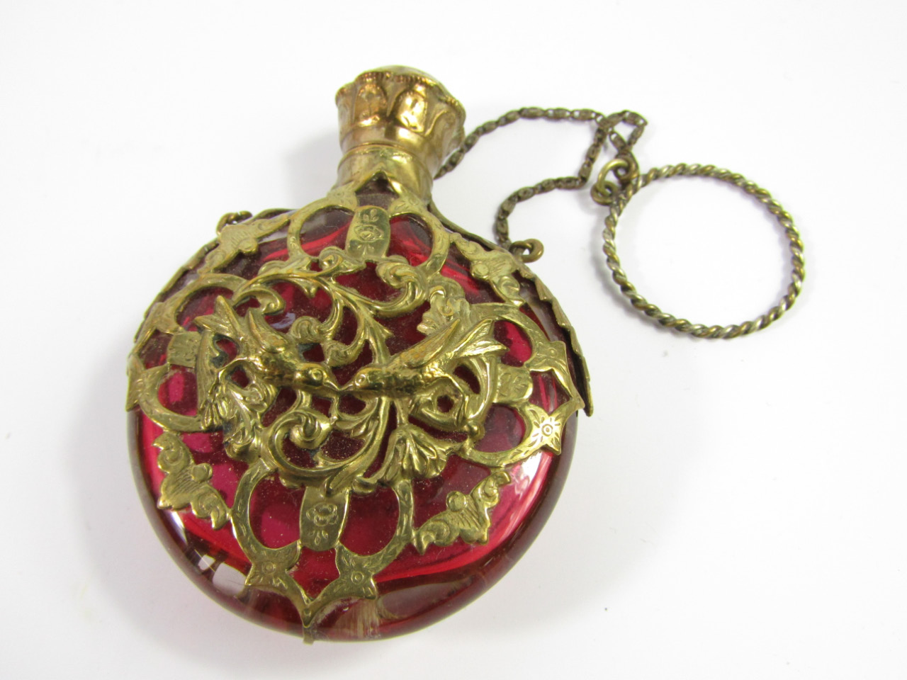 Appraisal: A Victorian cranberry glass scent bottle of compressed circular form