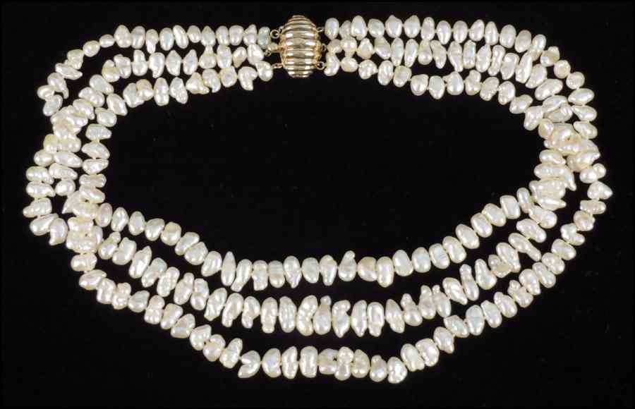 Appraisal: TRIPLE STRAND FRESHWATER PEARL NECKLACE With a karat yellow gold