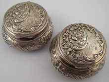 Appraisal: A pair of silver circular boxes with embossed decoration bearing