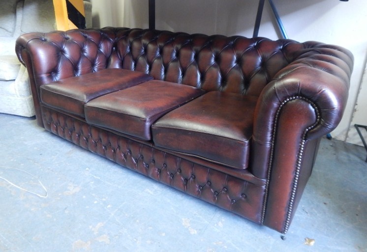 Appraisal: A Saxon brown leather Chesterfield three seat sofa cm wide