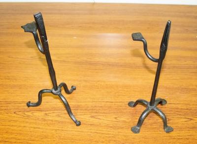 Appraisal: Two th Century style wrought iron rush-light holders with weighted