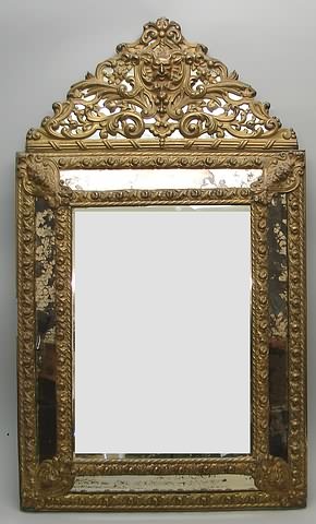 Appraisal: Beveled edge mirror surrounded by floral relief decorated brass trim