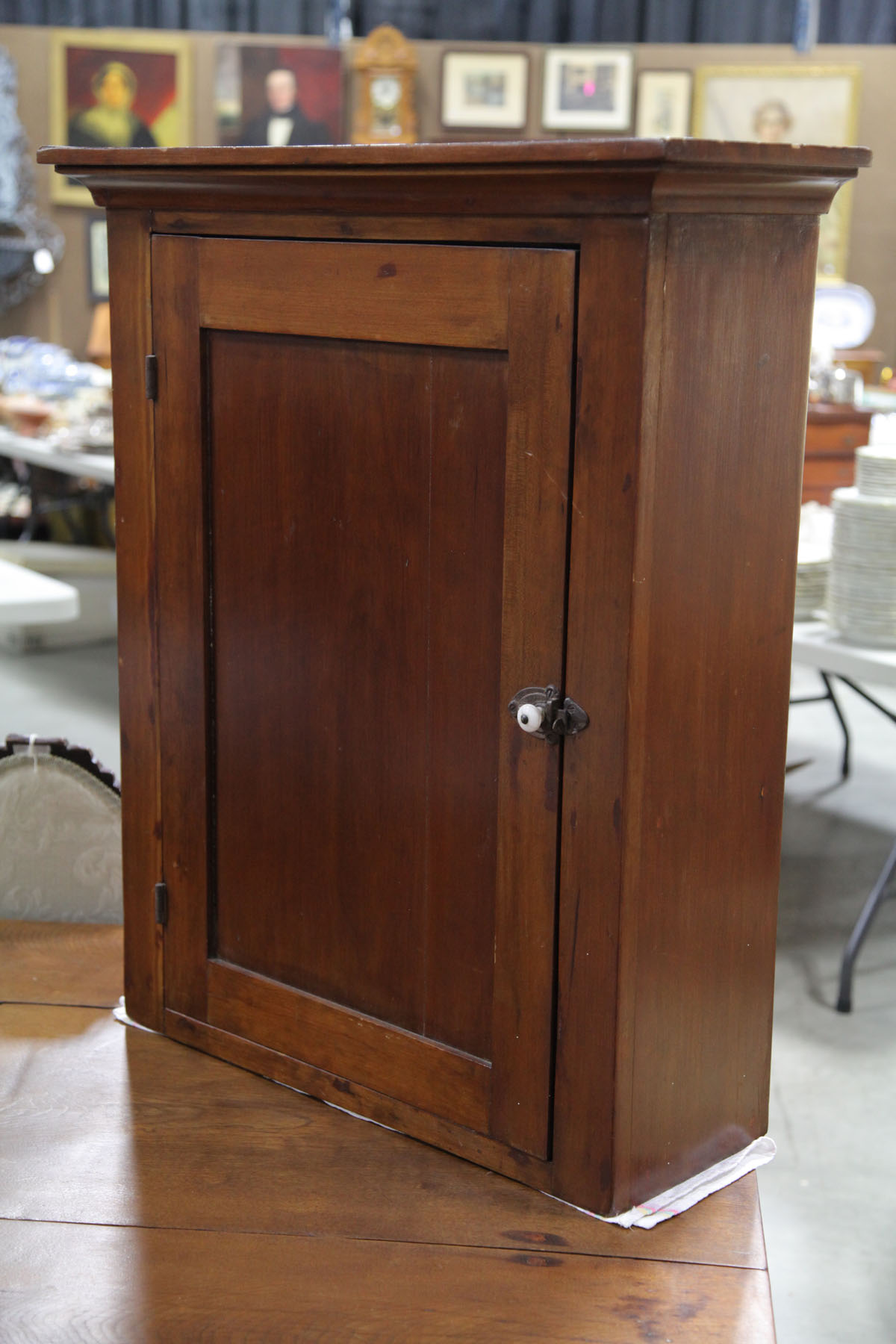 Appraisal: HANGING CUPBOARD American late th century Walnut cupboard with molded