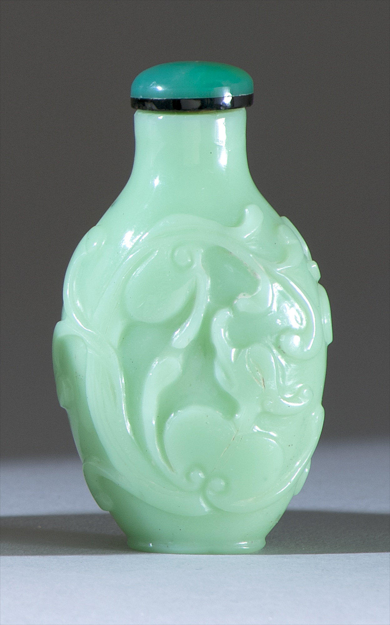 Appraisal: PALE GREEN GLASS SNUFF BOTTLE th CenturyIn elongated ovoid form