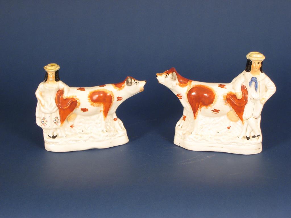 Appraisal: Pair of Staffordshire Cow Creamers with boy and girl figures