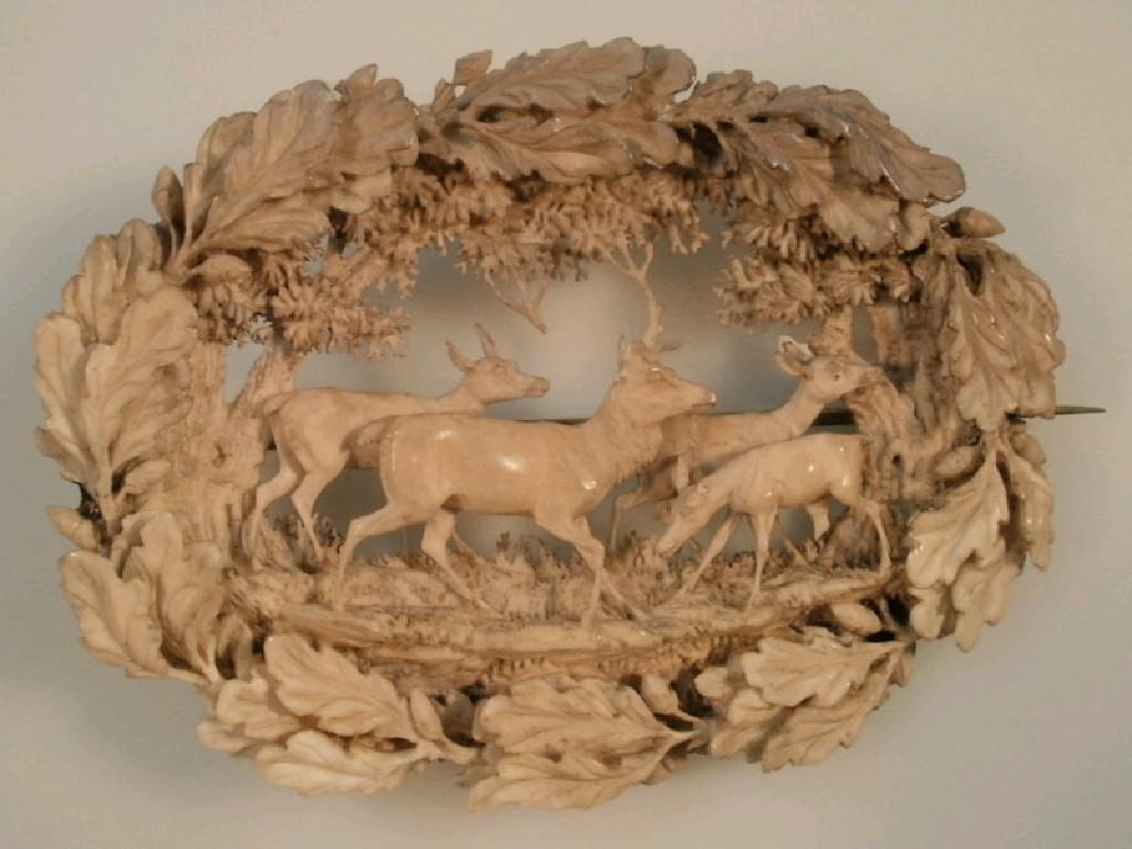 Appraisal: Victorian carved and pierced oval ivory brooch designed with deer