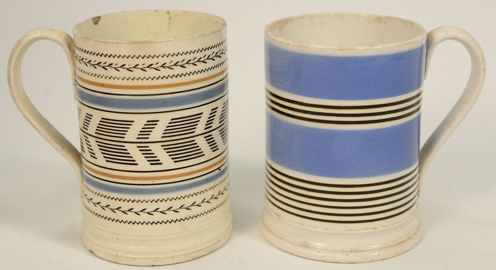 Appraisal: Two Mocha Mugs each with engine turnings and vines one