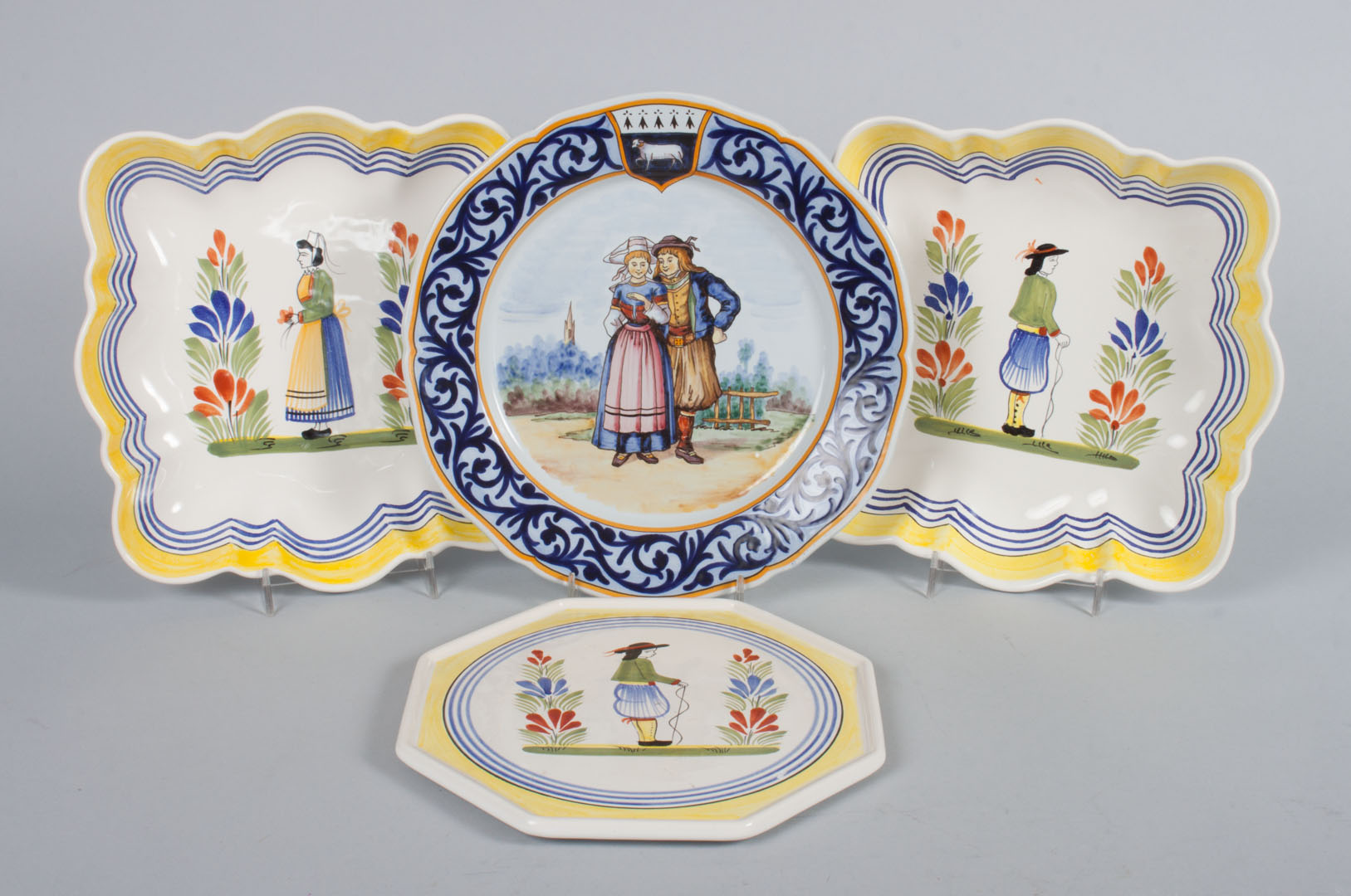 Appraisal: Four Henriot Quimper faience objects including trivet pair of square