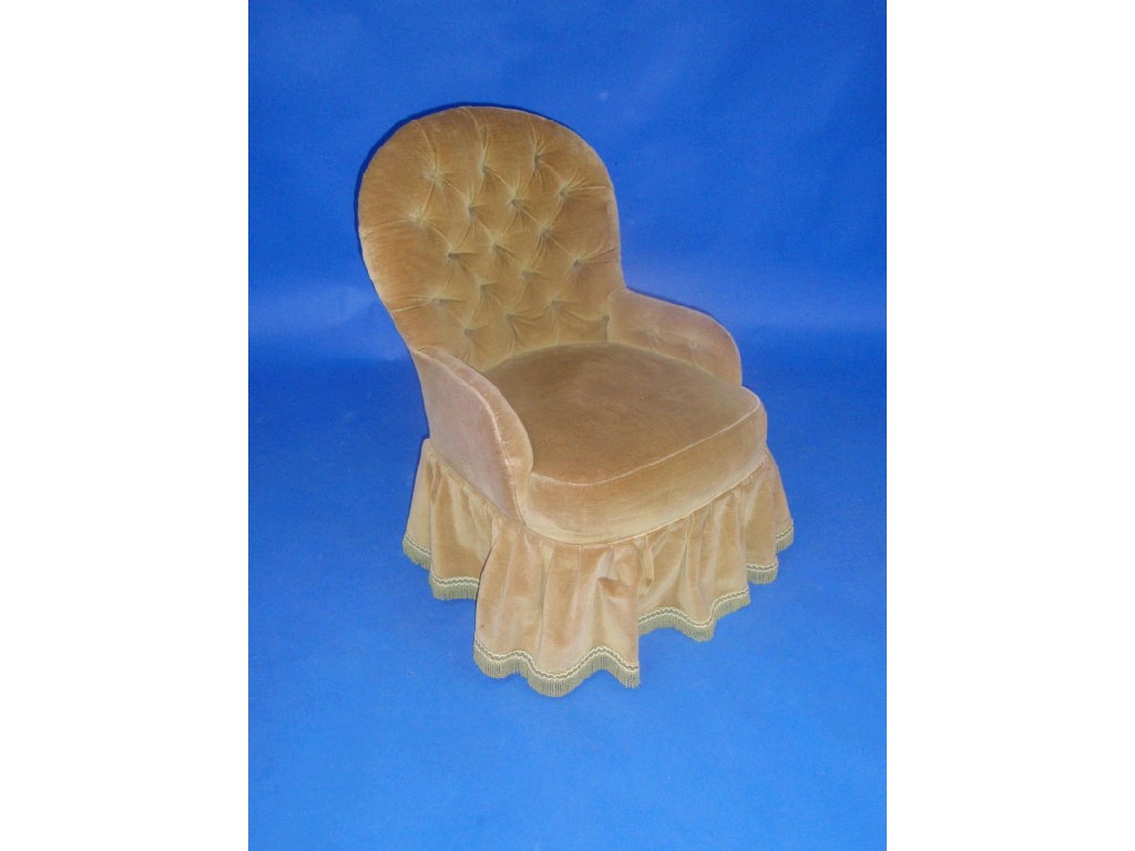 Appraisal: A button dralon upholstered chair with ball and claw feet