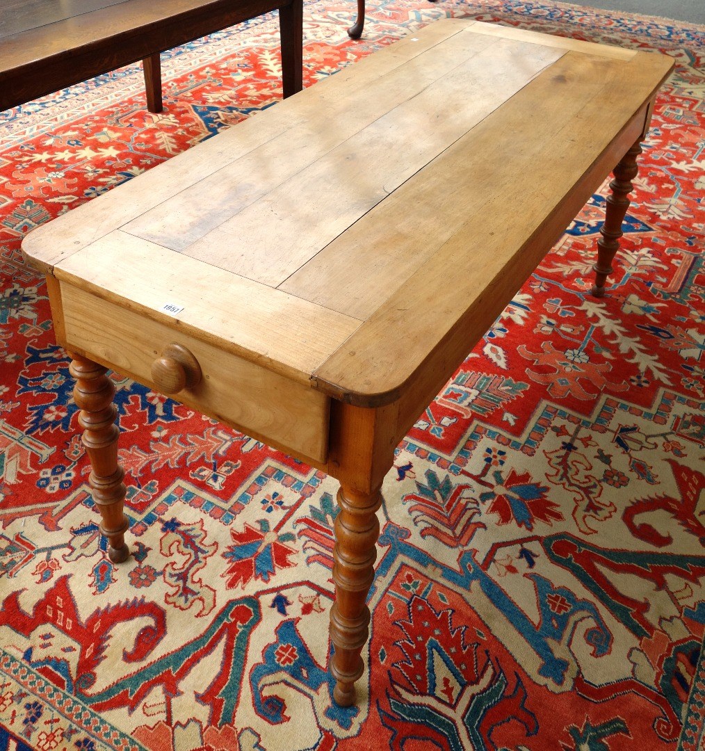 Appraisal: A th century French fruitwood kitchen table the plank top