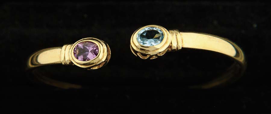 Appraisal: AMETHYST AND BLUE TOPAZ K BANGLE BRACELET Yellow gold bracelet