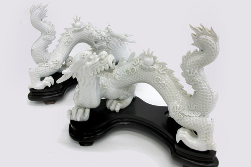 Appraisal: PAIR BLANC DE CHINE DEHAU PORCELAIN FIGURES OF DRAGONS five-toed