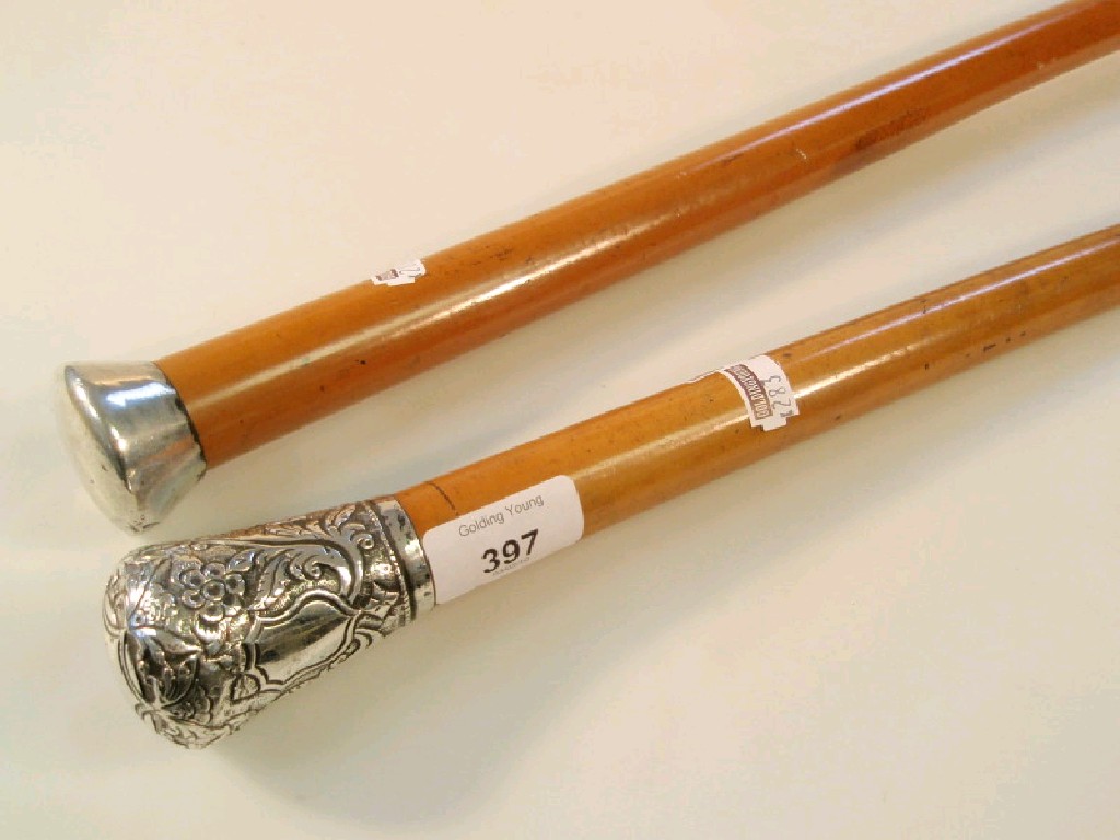 Appraisal: Two Victorian mallaca dandy canes with white metal knops