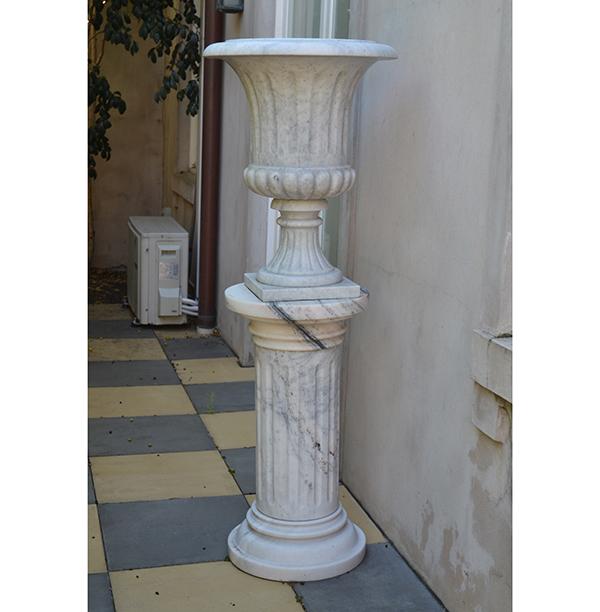 Appraisal: A CLASSICAL STYLE FLUTED MARBLE URN ON A COLUMNAR MARBLE