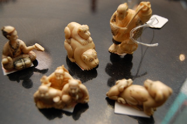 Appraisal: A COLLECTION OF FIVE JAPANESE IVORY NETSUKE Carved with subjects