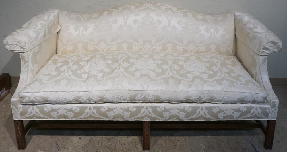 Appraisal: SOUTHWOOD CHIPPENDALE STYLE MAHOGANY CHAMPAGNE UPHOLSTERED CAMEL-BACK SOFA L IN