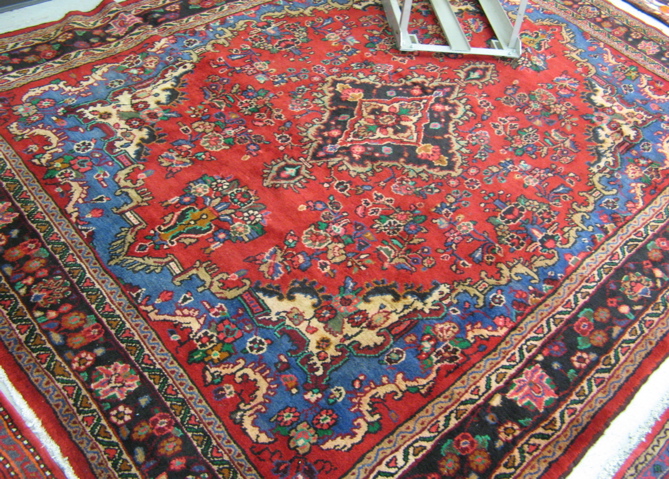 Appraisal: PERSIAN CARPET floral and central floral medallion design on red