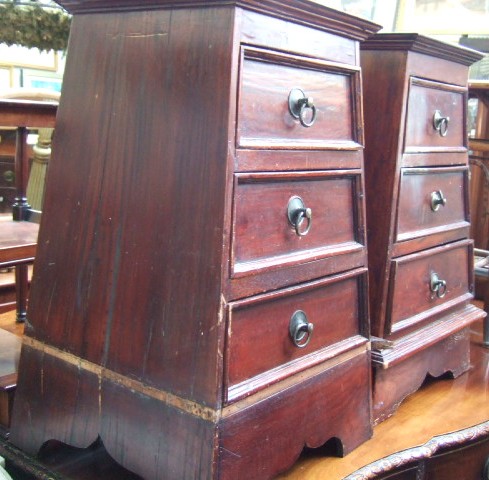 Appraisal: A pair of th century hardwood three drawers bedside tables