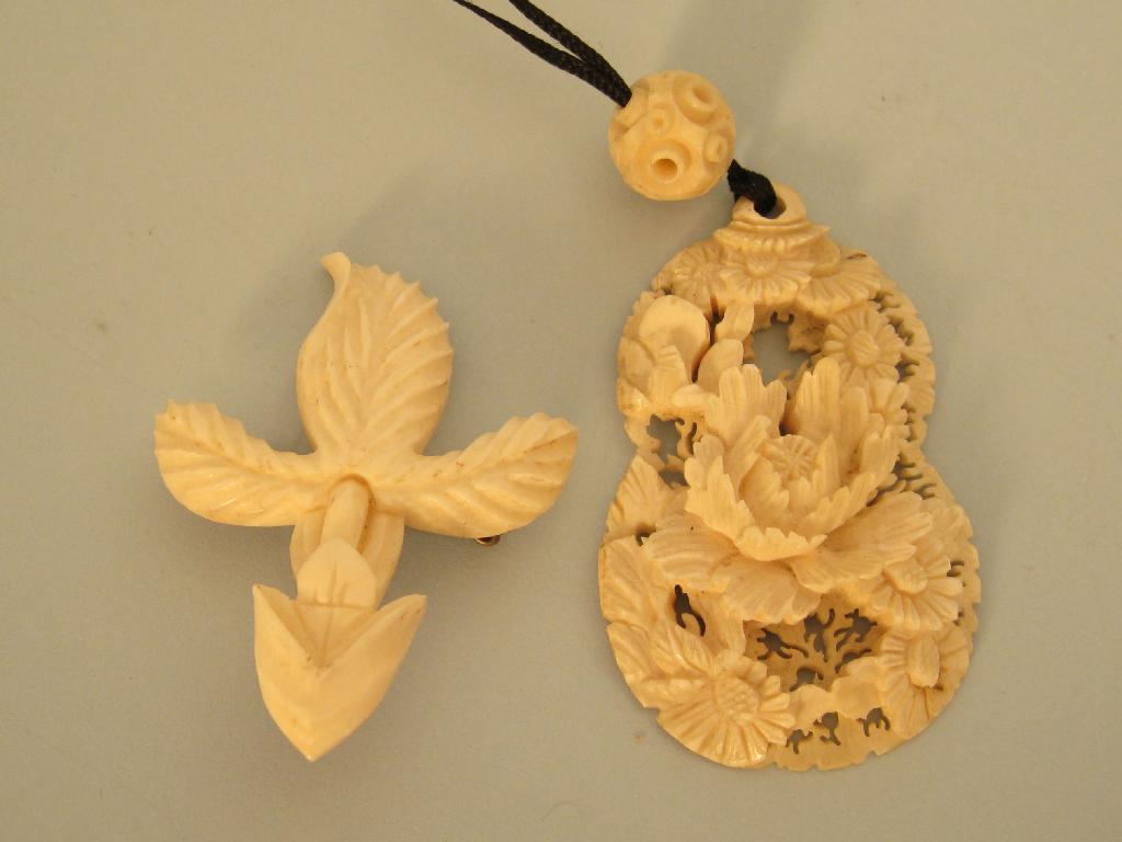 Appraisal: A Cantonese floral carved ivory Pendant and an ivory Brooch